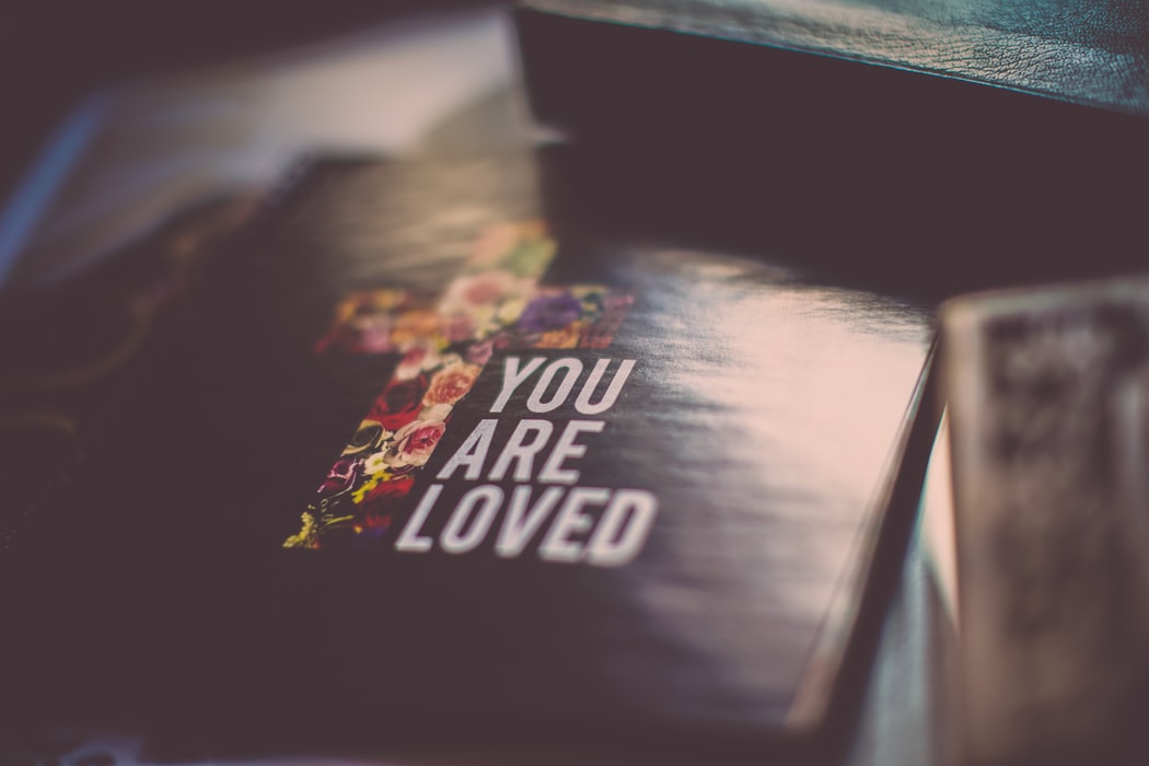 Image of bible with text 'you are loved'